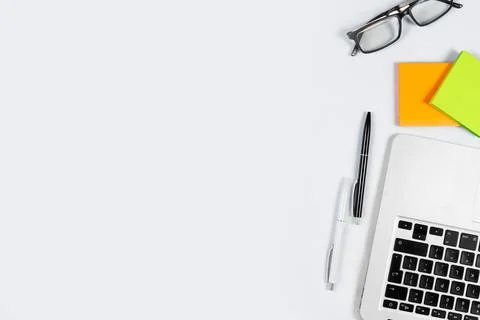 Working table top view, flat lay. Business items on a white table, laptop, cl Stock Photos