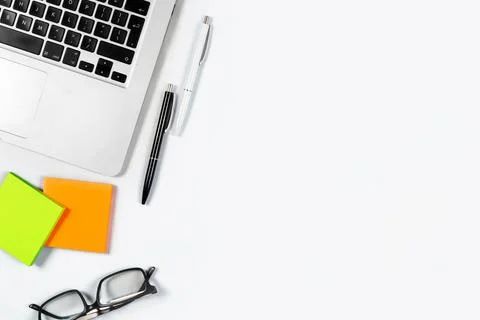 Working table top view, flat lay. Business items on a white table, laptop, cl Stock Photos