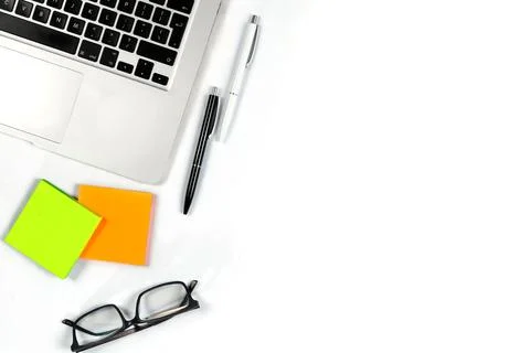 Working table top view, flat lay. Business items on a white table, laptop, cl Stock Photos