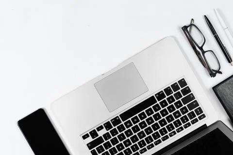 Working table top view, flat lay. Business items on a white table, laptop, cl Stock Photos