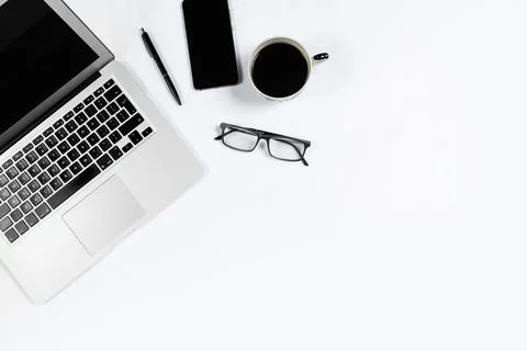 Working table top view, flat lay. Business items on a white table, laptop, cl Stock Photos