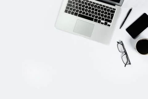 Working table top view, flat lay. Business items on a white table, laptop, cl Stock Photos