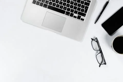 Working table top view, flat lay. Business items on a white table, laptop, cl Foto stock