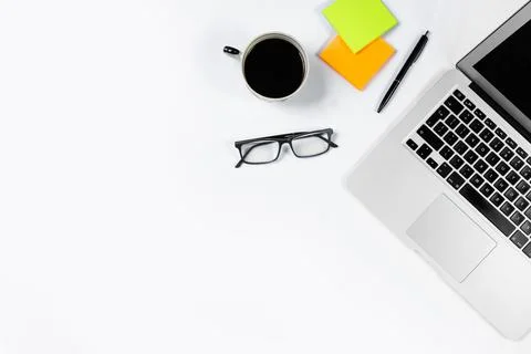 Working table top view, flat lay. Business items on a white table, laptop, cl Stock Photos