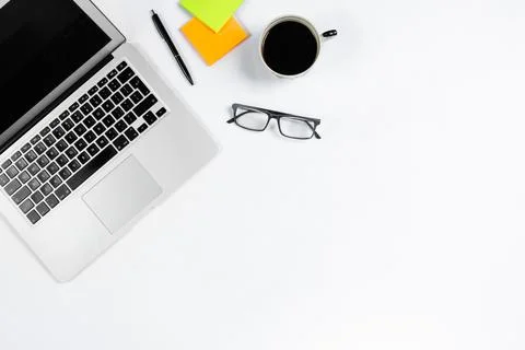 Working table top view, flat lay. Business items on a white table, laptop, cl Stock Photos