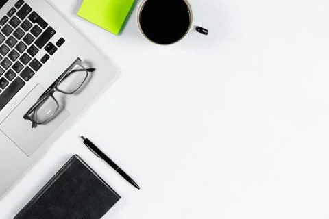 Working table top view, flat lay. Business items on a white table, laptop, ph Stock Photos