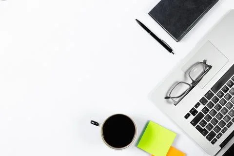 Working table top view, flat lay. Business items on a white table, laptop, ph Stock Photos