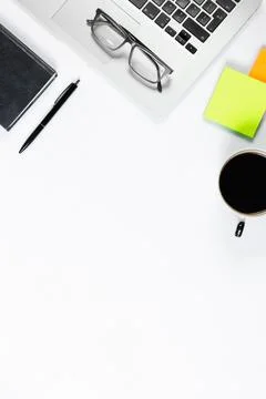 Working table top view, flat lay. Business items on a white table, laptop, ph Stock Photos