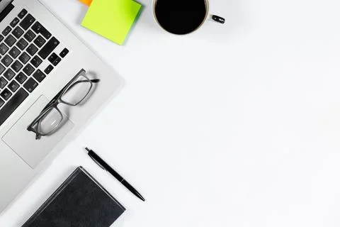 Working table top view, flat lay. Business items on a white table, laptop, ph Stock Photos