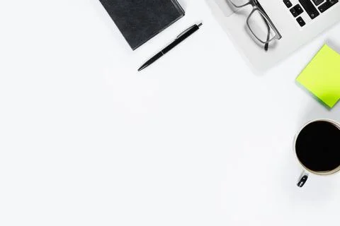 Working table top view, flat lay. Business items on a white table, laptop, ph Stock Photos