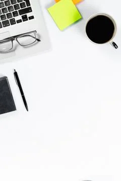 Working table top view, flat lay. Business items on a white table, laptop, ph Stock Photos