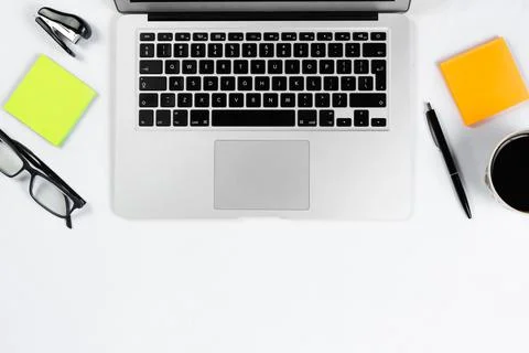 Working table top view, flat lay. Business items on a white table, laptop, ph Stock Photos