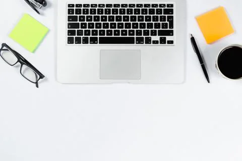 Working table top view, flat lay. Business items on a white table, laptop, ph Stock Photos