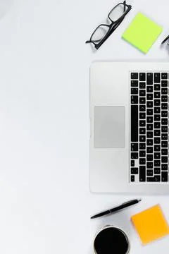 Working table top view, flat lay. Business items on a white table, laptop, ph Stock Photos