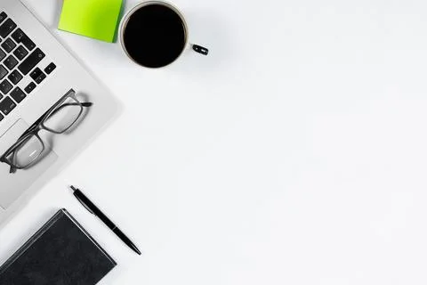 Working table top view, flat lay. Business items on a white table, laptop, ph Stock Photos