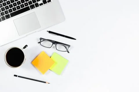 Working table top view, flat lay. Business items on a white table, laptop, ph Stock Photos