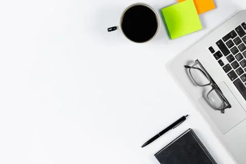 Working table top view, flat lay. Business items on a white table, laptop, ph Stock Photos