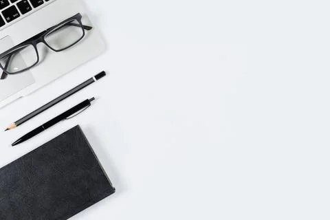 Working table top view, flat lay. Business items on a white table, laptop, ph Stock Photos