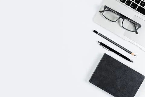 Working table top view, flat lay. Business items on a white table, laptop, ph Stock Photos