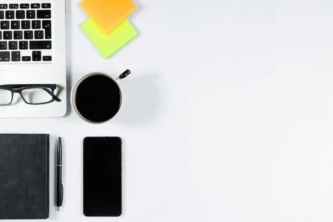 Working table top view, flat lay. Business items on a white table, laptop, ph Stock Photos