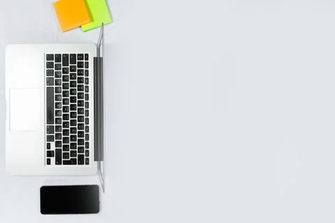 Working table top view, flat lay. Business items on a white table, laptop, ph Stock Photos
