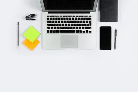 Working table top view, flat lay. Business items on a white table, laptop, cl Stock Photos