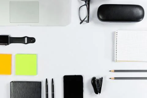 Working table top view, flat lay. Business items on a white table, laptop, cl Stock Photos