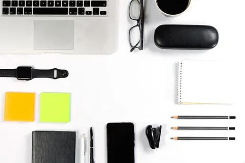 Working table top view, flat lay. Business items on a white table, laptop, cl Stock Photos