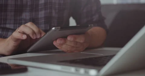 Working with tablet and laptop at desk Stock Footage 320945533