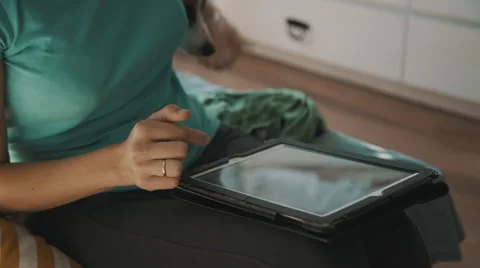 Working on tablet pc and play with her dog Stock Footage 54365440