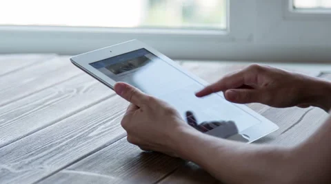 Working on tablet pc on wooden desk Stock Footage 52370655