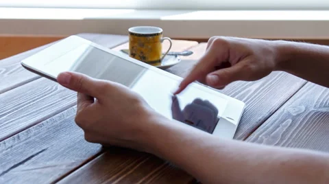 Working on tablet pc on wooden desk Stock Footage 52373732