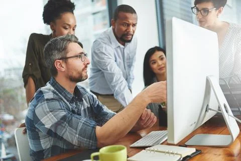 Working together to get the task done. Shot of businesspeople working together Stock Photos