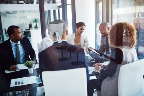 Working together for a shared goal. a team of professionals having a meeting in Stock Photos