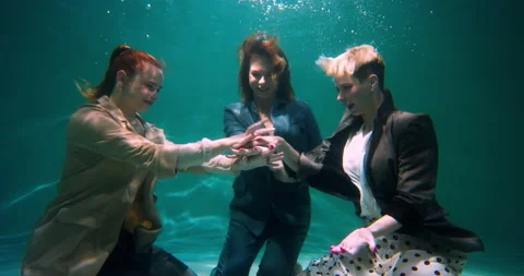 Working together. Three beautiful happy business women in formal clothes join Stock Footage 171876130