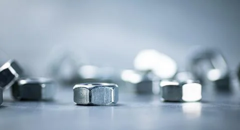 Working tool. Metal nuts on the table. Stock Photos