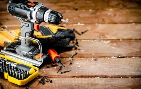 Working tool. Screwdriver with self-tapping screws on the table. Stock Photos
