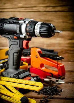 Working tool. Screwdriver with self-tapping screws on the table. Stock Photos