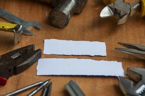 Working tools with blank torn papers on wooden table. Copy space concept. Stock Photos