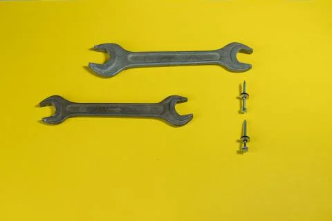 Working tools on a colored background isolated with screws Stock Photos