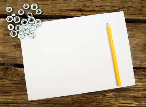 Working tools. The Sheet of paper with a pencil and fixing elements, wrenches Foto stock