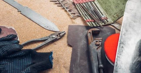 Working tools on wooden rustic background. top view. Knife making concept Stock Photos