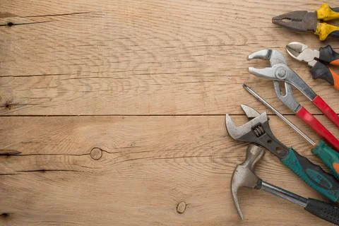 Working tools on a wooden rustic background. Top view with an empty place for Stock Photos