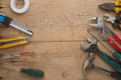 Working tools on a wooden rustic background. Top view with an empty place for Stock Photos
