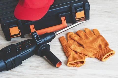 Working tools.rotary hammer, tool box, work cap, gloves, Stock Photos