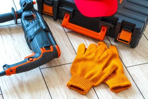 Working tools.rotary hammer, tool box, work cap, gloves, Stock Photos