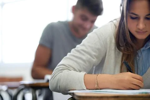 Working towards their future. young college students hard at work in class. Stock Photos