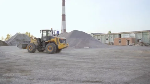 Working tractor on field of sand and gravel. Ukrainian cement plant. Stock Footage 171464631
