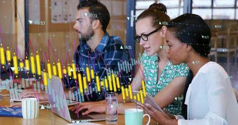 Working trio in office attire checking market charts at meeting table with Stock Photos