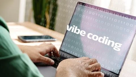 Working on vibe coding with a laptop during a daytime session indoors 写真素材